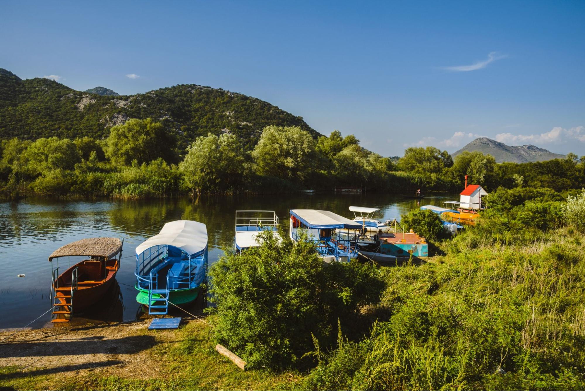 Awesome view of Skadar lake surrounded by green mountain peaks on a sunny day. Location: National park Skadar Lake, Montenegro, Balkans, Europe