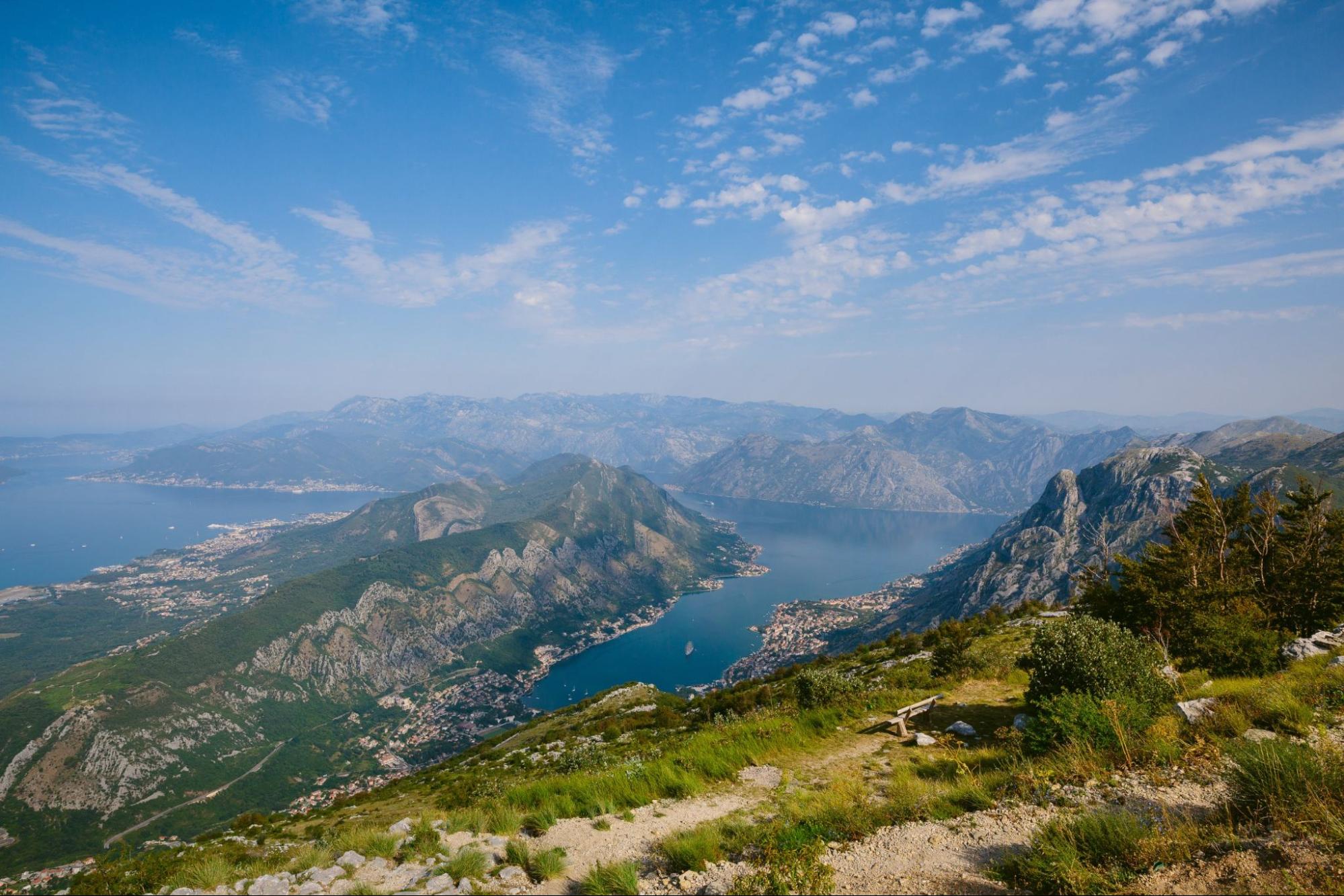 Bay of Kotor from the heights. View from Mount Lovcen to the bay. View down from the observation platform on the mountain Lovcen. Mountains and bay in Montenegro. The liner near the old town of Kotor.